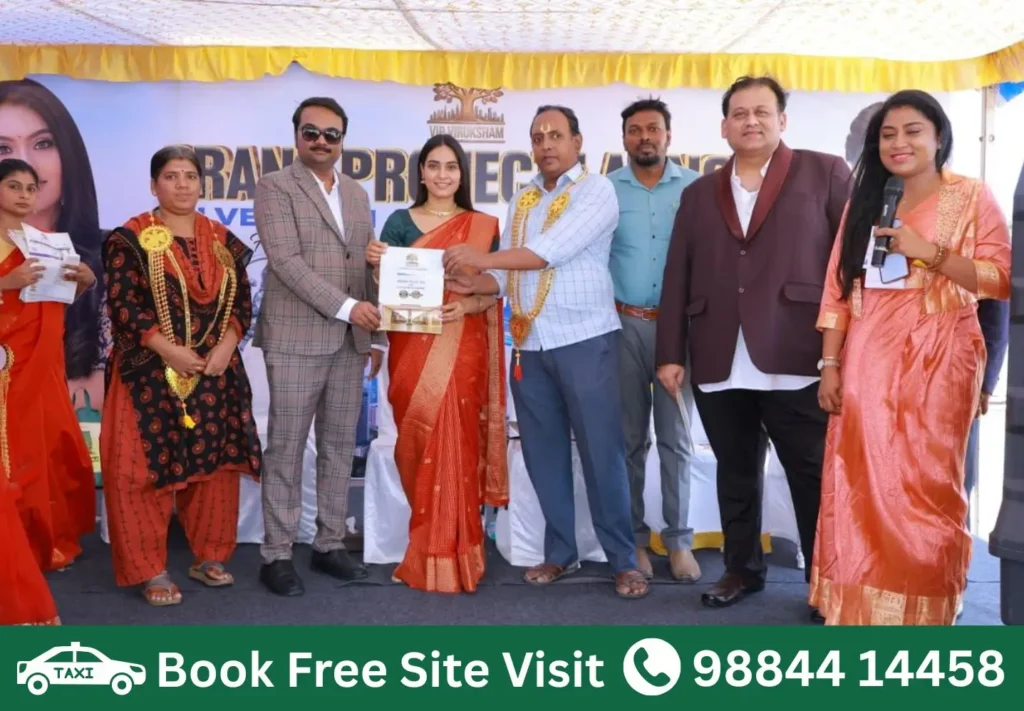 Customer receiving plot booking certificate at VIP Viruksham Singaperumal Koil premium gated community villa plots project launch